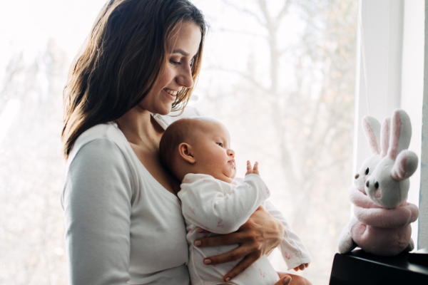 10 Simple Ways Busy Moms Can Improve Their Mental Health

(description: Smiling mother holding baby while looking at two stuffed rabbit toys.)